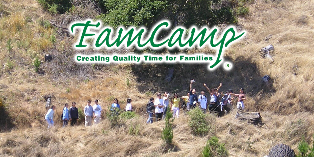 A group of kids are standing on a hillside and waving to the camera. The words "FamCamp Creating Quality Time for Families" is shown above them
