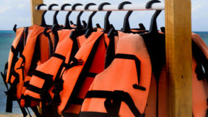 Life jackets hanging on a rack.
