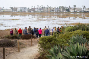 An interpreter is talking to crowd in by the Tijuana River Estuary
