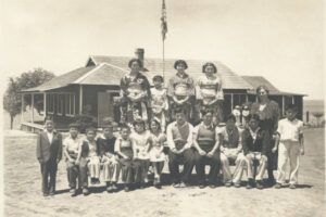 A historical black and white photo Japanese immigrants posing at the now Crystal Cove State Park