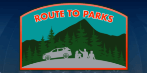 Route to Parks logo. An illustration of a silhouette of a car and three people, with trees and a mountain in the background.