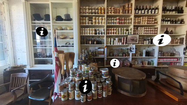 Catalyst Shasta A restored general store: A cabinet with historic hats on display. Shelves stocked with historic goods. A table with a display of canned goods