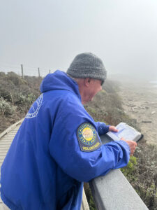 Docent Jim Mentgen overlooks the elephant seal rookery, ready to interpret to visitors.