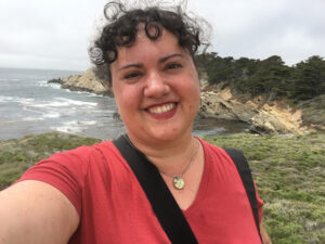 Photograph portrait of a woman standing on the coastal bluffs of Point Lobos SNR.