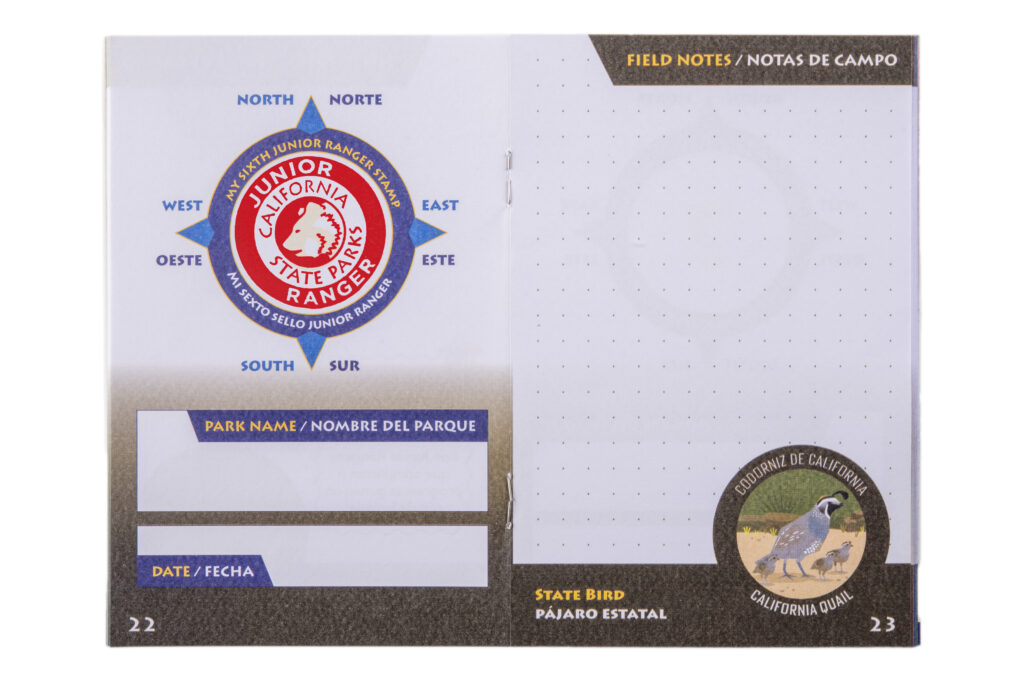 Detail photograph of a page depicting a compass rose stamped with the image of a bear head and the words "Junior Ranger California State Parks"