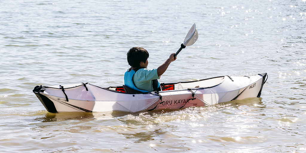 A fourth grade student is kayaking.